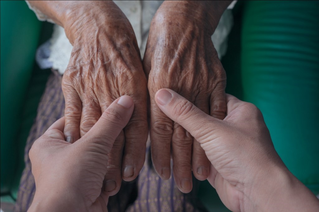 young-woman-holding-an-elderly-woman-s-hand.jpg